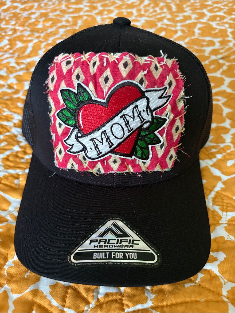 Pacific Headwear Black Trucker Hat with Red MOM Heart Patch